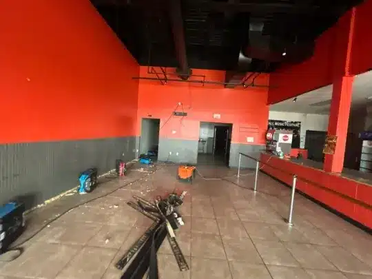 Commercial space with restoration equipment and debris.
